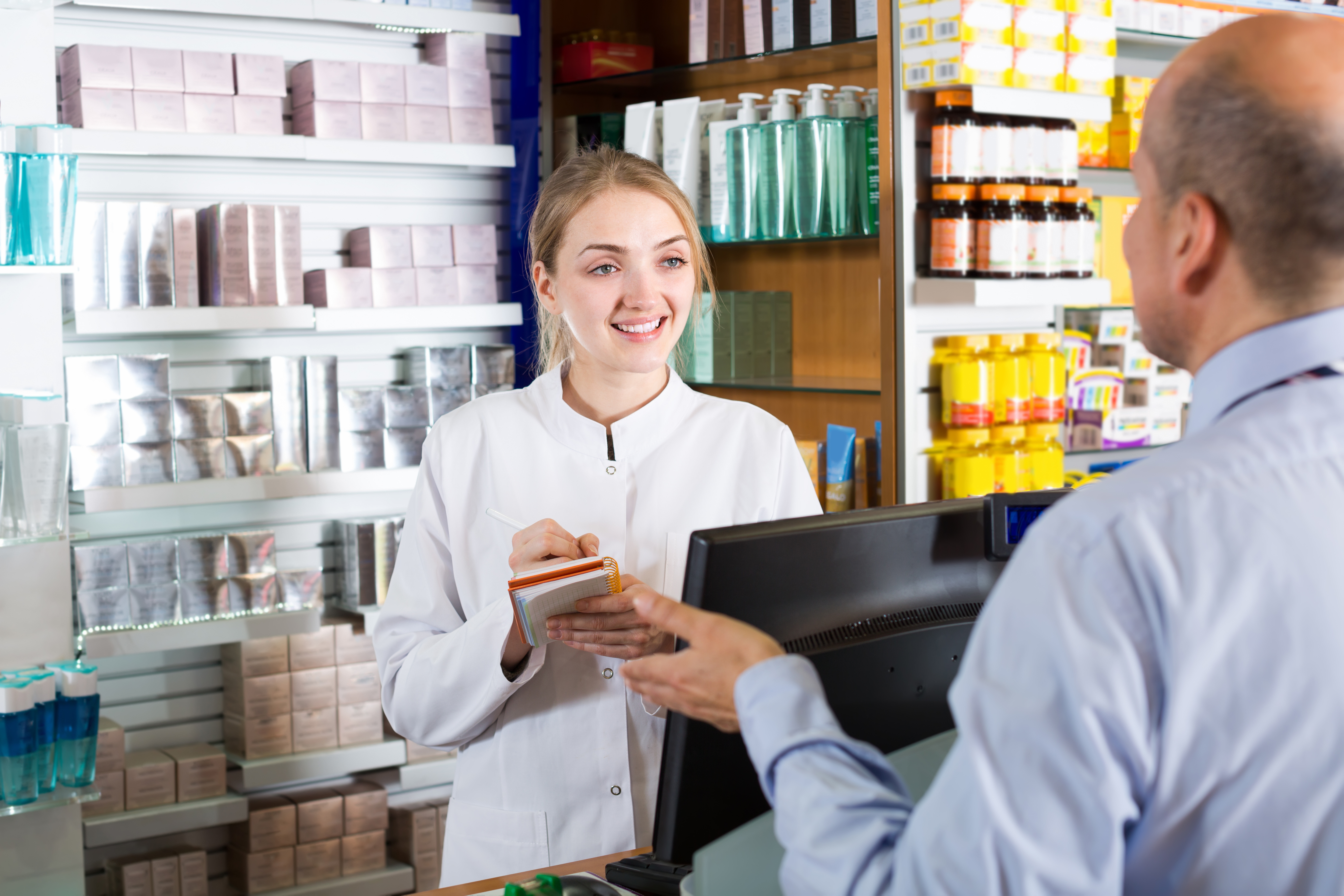 a pharmacy technician assisting a patient