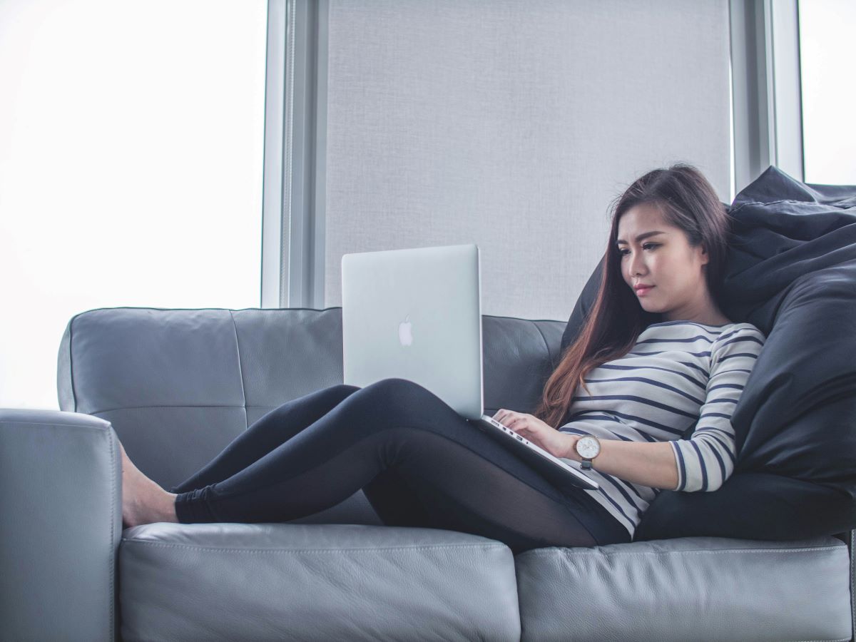 Woman on couch with laptop