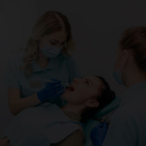 dental assistant supporting dental surgery in oral surgery practice