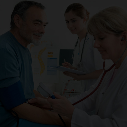 Medical assistant measuring patient vital signs in doctor’s office